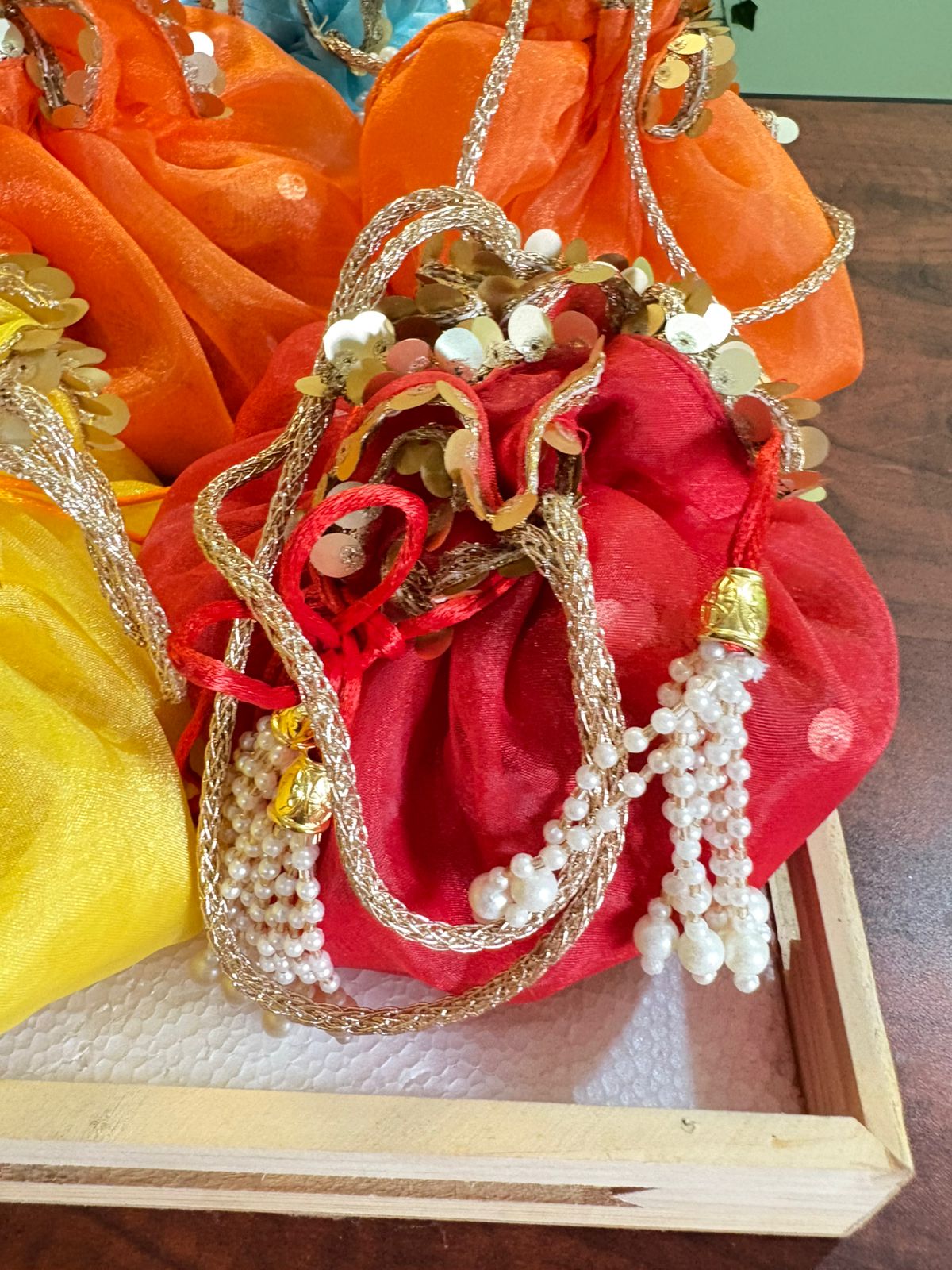 Scrunchy Organza potli with golden handle and golden sequins lace - Image 4